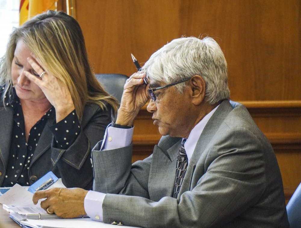Director of Internal Audit, Manu Patel, analyze the Audit and Compliance committee meeting agenda on Oct. 18, 2017, at Scholes Hall before going into executive session. 