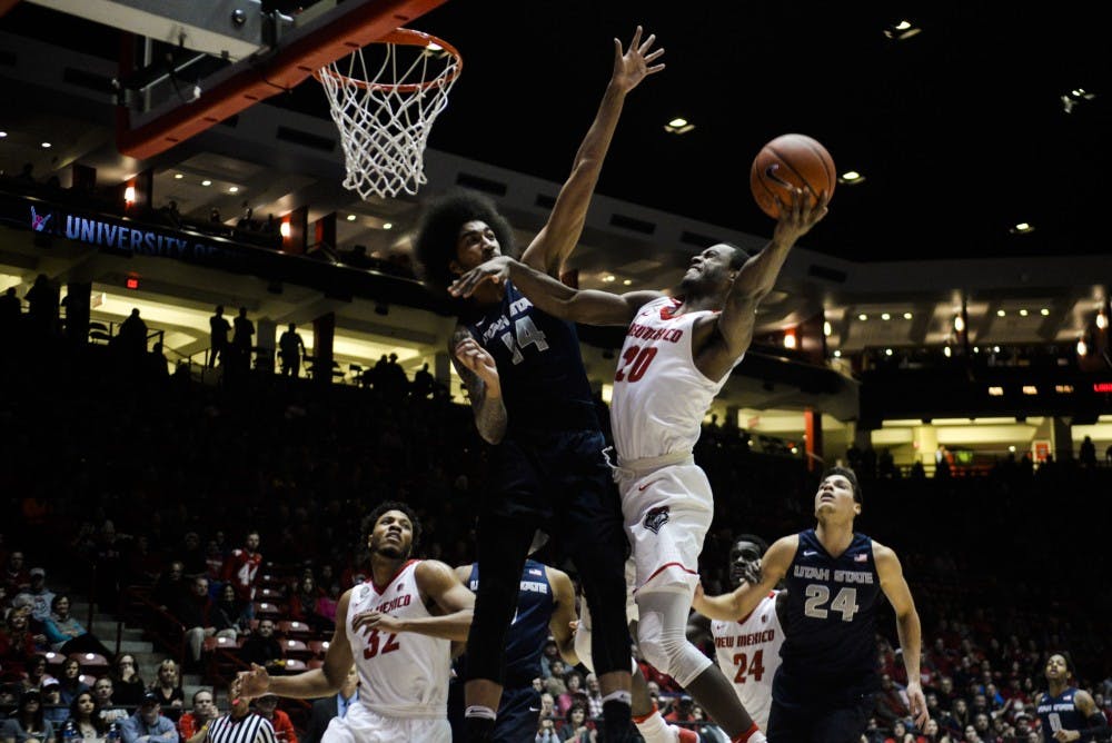 Junior guard Sam Logwood leaps through a Utah State defender Tuesday, Jan. 24, 2017 at WisePies Arena. Nevada ended the Lobos’ four-game winning streak, 82-65, on Saturday, Jan. 28, 2017.
