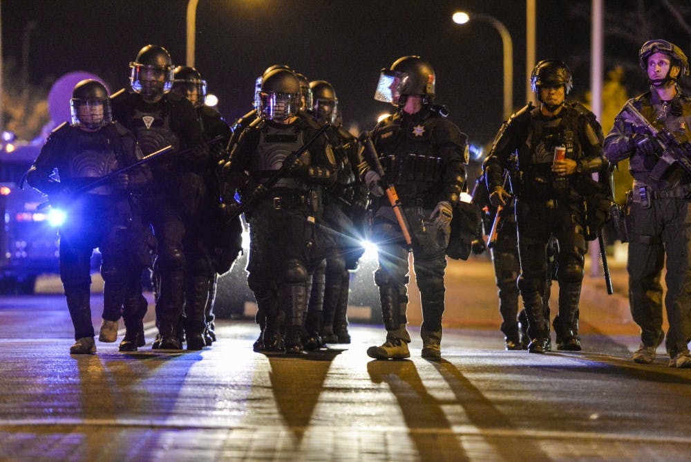 Albuquerque riot police march down 5th street Wednesday Oct. 12, 2016 in downtown Albuquerque. Riot police along with SWAT units where dispatched to a protest regarding the mistrial decision in the two police officers who shot James Boyd.&nbsp;