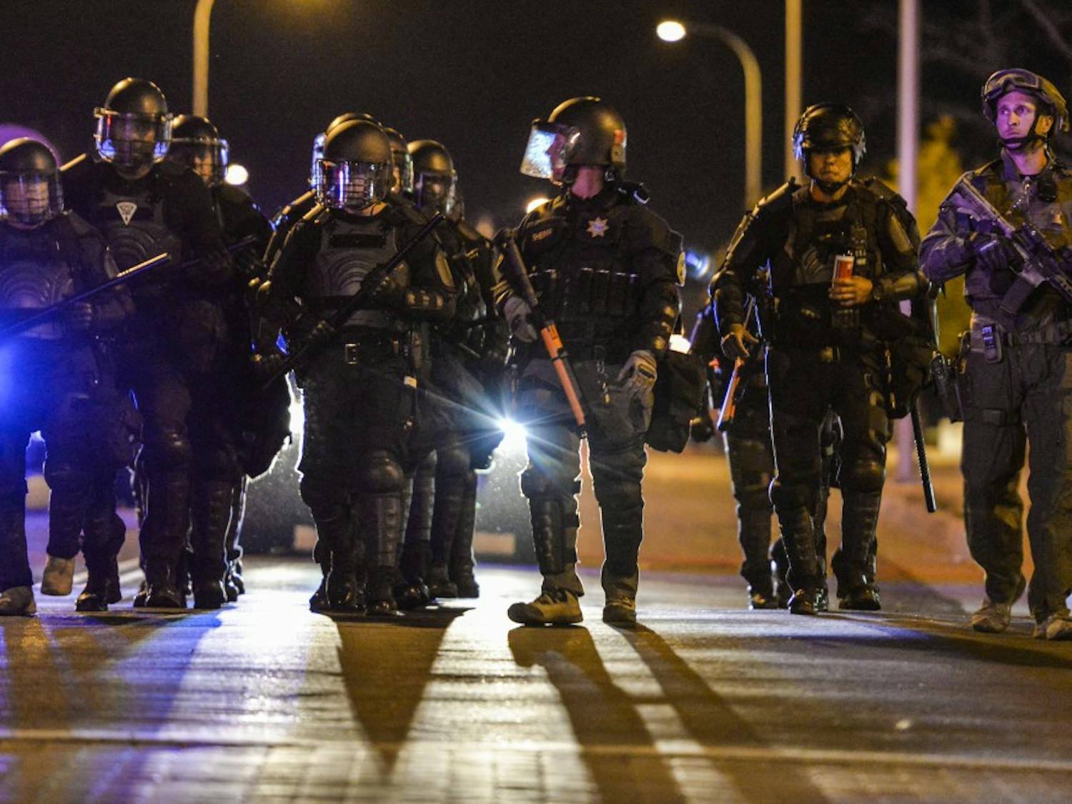 Albuquerque riot police march down 5th street Wednesday Oct. 12, 2016 in downtown Albuquerque. Riot police along with SWAT units where dispatched to a protest regarding the mistrial decision in the two police officers who shot James Boyd. 