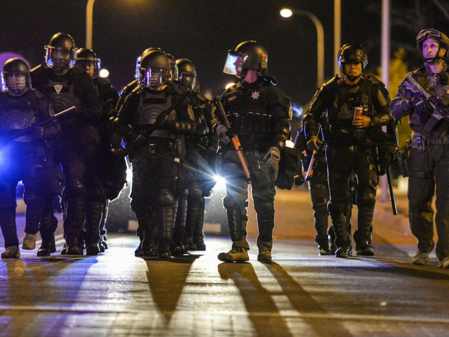 Albuquerque riot police march down 5th street Wednesday Oct. 12, 2016 in downtown Albuquerque. Riot police along with SWAT units where dispatched to a protest regarding the mistrial decision in the two police officers who shot James Boyd.&nbsp;