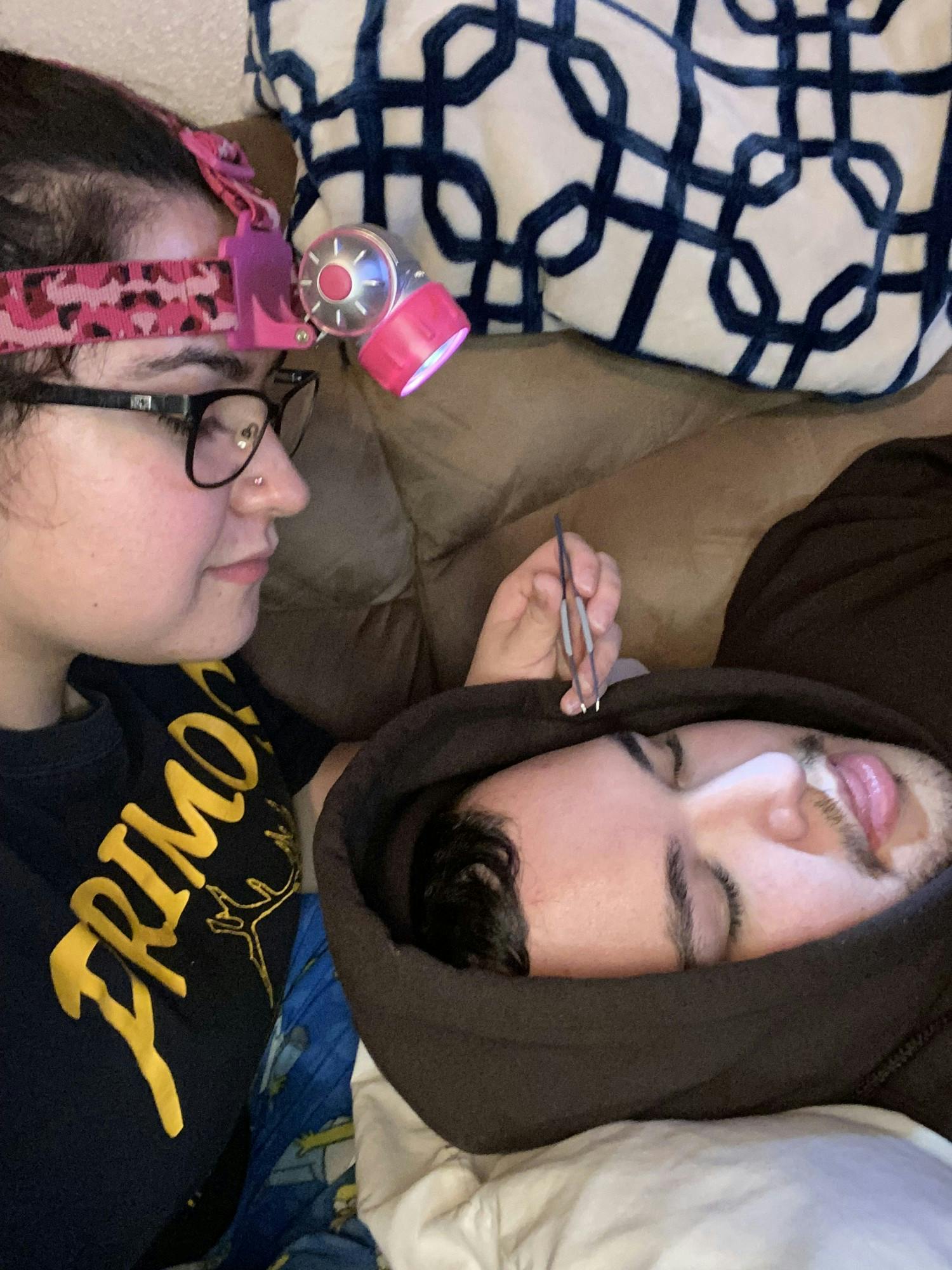 Jade tweezing brother Dylan’s eyebrows.JPG