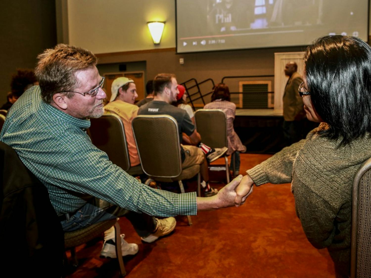 Loreal Black Shawl, right, shakes hands with Larry Ostrem at the Coach Ken Carter talk at the UNM SUB ballroom on Tuesday, Oct. 10, 2017.
