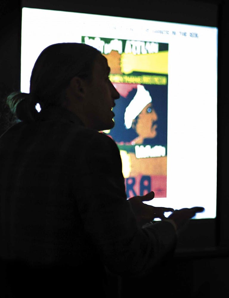 Doctoral candidate and 2006 Friends of the Arts Award recipient Dylan Miner gives a presentation on Chicano art, "With Our Heart in Our Hands and Our Hands in the Soil," at the Jonson Gallery on Tuesday. Miner, a member of the Woodland Metis Tribe of Onta