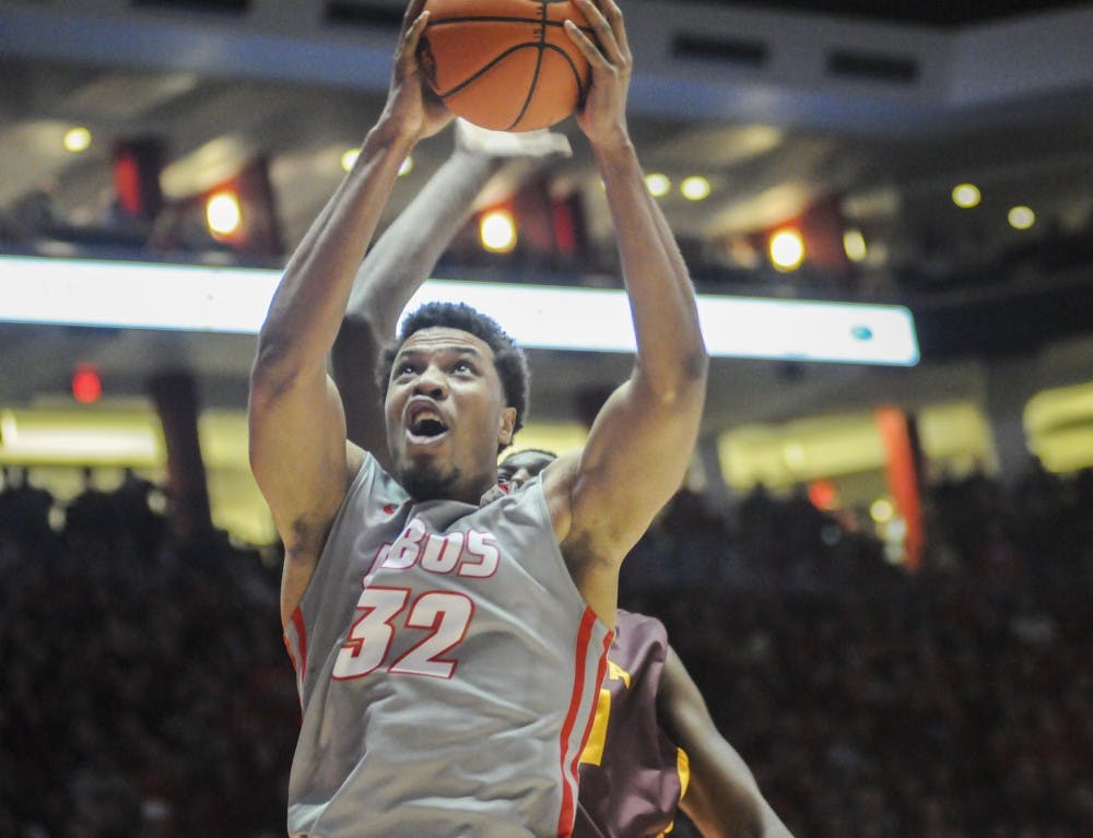 Redshirt junior forward Tim Williams reaches past a Loyola player Wednesday Nov. 18 at WisePies Arena. The Lobos played USC this past Saturday and lost 90-82.
