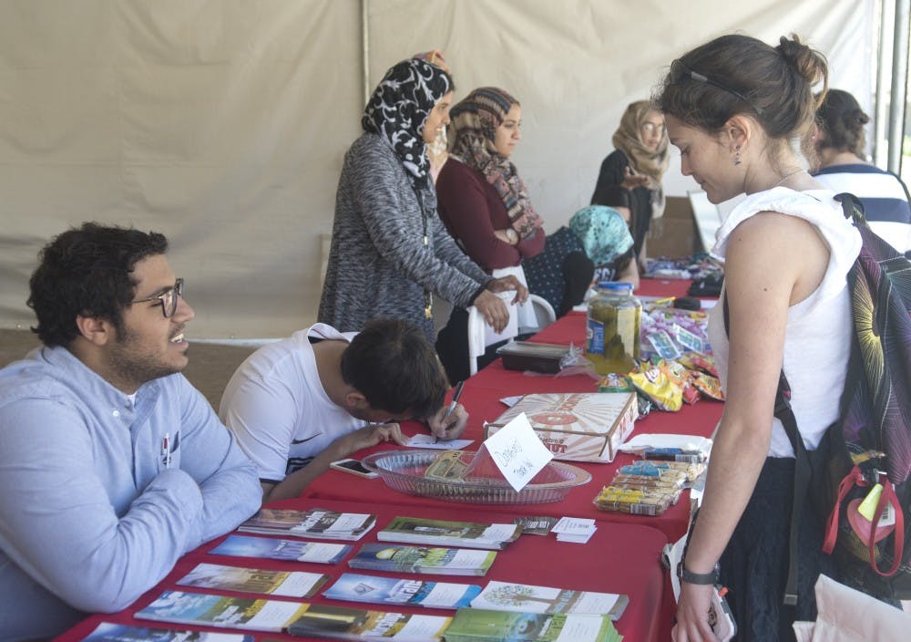 UNM Students ask questions about Islam during Islam Awareness Week organized by MSU. The stand will be in Zimmerman Plaza through Friday.