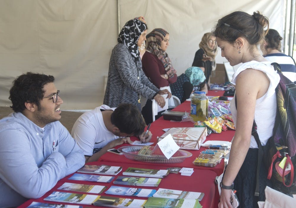 UNM Students ask questions about Islam during Islam Awareness Week organized by MSU. The stand will be in Zimmerman Plaza through Friday.
