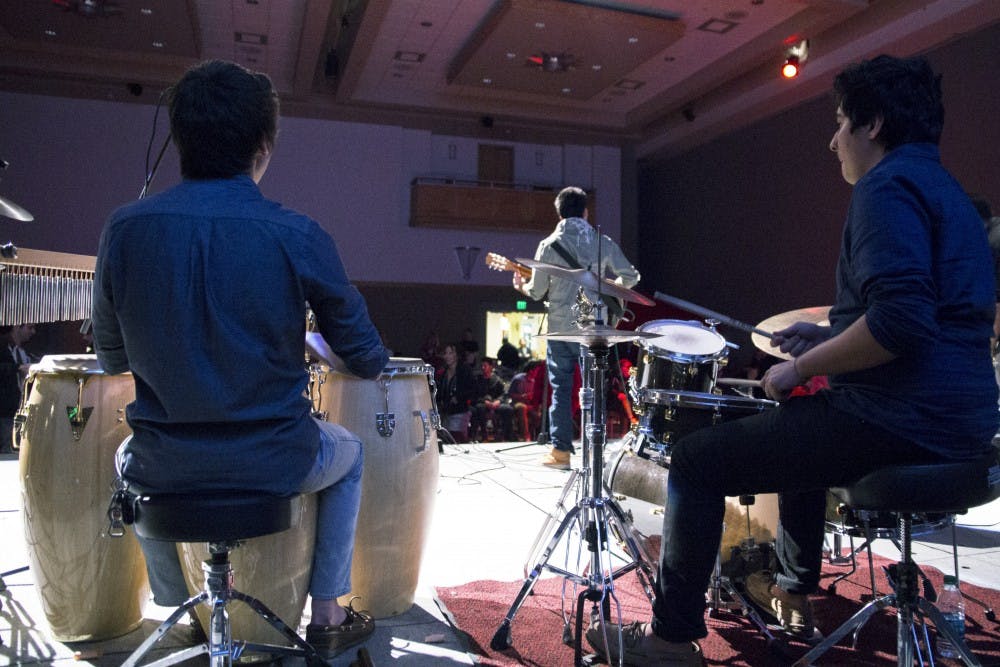  Sol De La Nochess Oscar Gambia, left,and Ryan Rael play drums and percussion Wednesday night at the Fight for Fiestas Battle of the Bands in the SUB Ballroom. Competing against four other bands Sol De La Noche came out on top and will be featured at the 2015 summer Fiestas. 