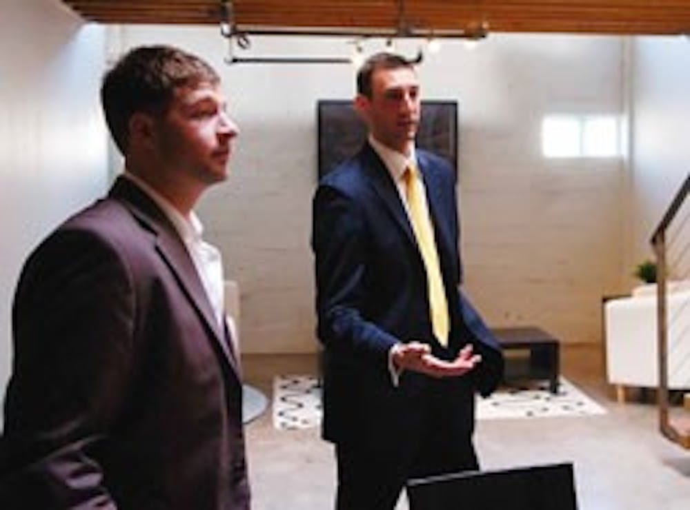 Ryan Bromberg, left, and Travis Thom of Venture Realty Group talk about first-time home buyers in Silver Hill Lofts on Gold Avenue and Buena Vista Drive on Tuesday. 