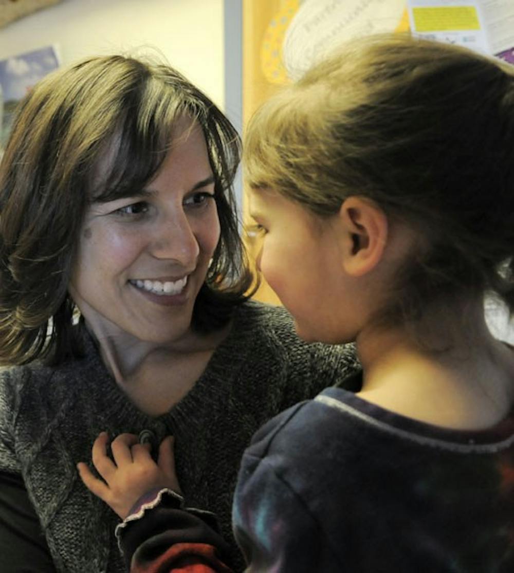 Kamilla Venner talks to her daughter, 4-year-old Calista Aragon, at the Children's Campus on Friday. About 350 children remain on the center's waiting list, where it can take up to two years for a spot to open.