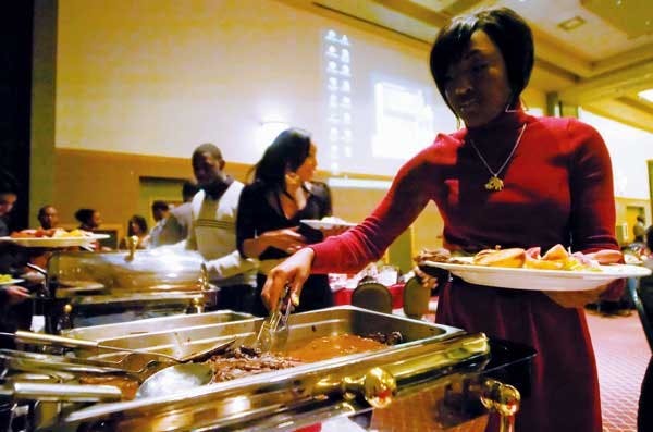 Student Tiyana Peters gets food during the Winter Roots Festival in the SUB on Saturday. The festival celebrated all African-American communities and their beliefs. 
