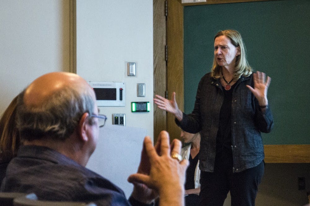Joyce Tennenson, a renowned photographer, gives a speaks to art students at the UNM Center for Arts Friday evening. The lecture was a walk through of her career and how she published books related to photography.