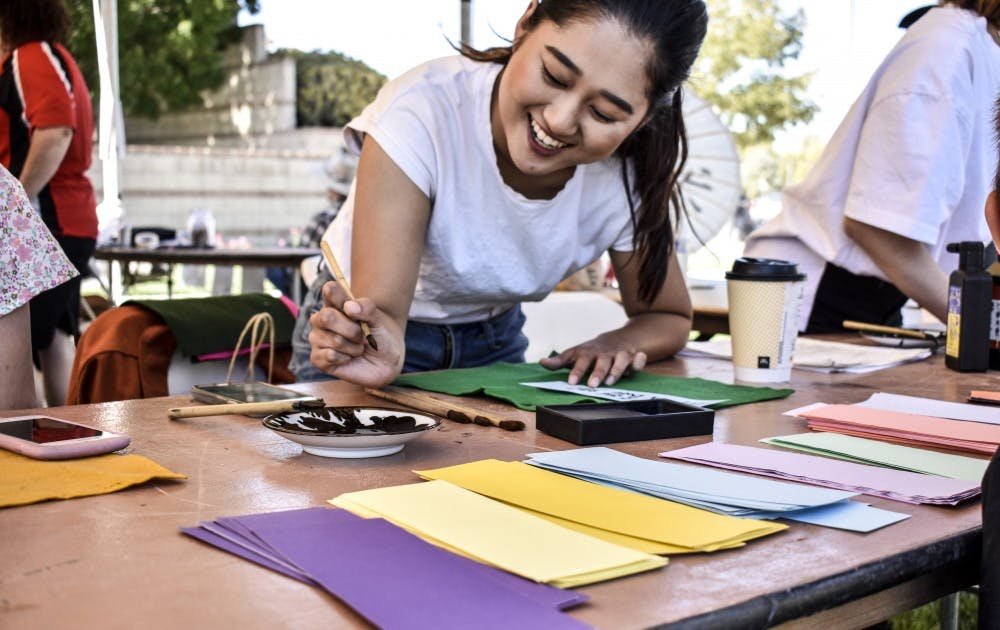 A volunteer demonstrates calligraphy at the Japanese fall festival on Sunday, Sept. 23.