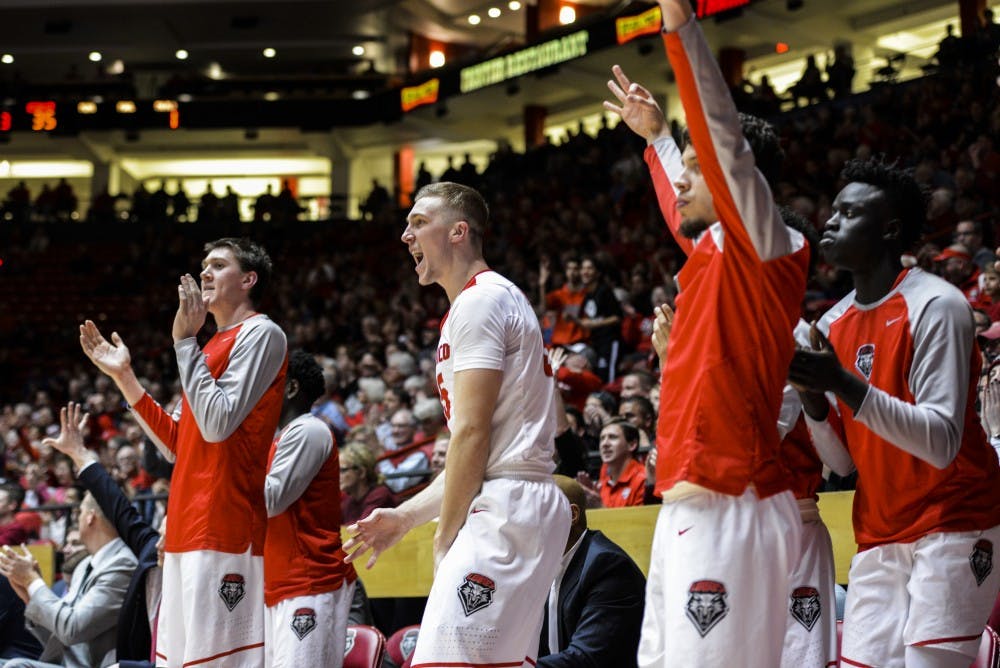 Redshirt sophomore forward Connor MacDougall, center, celebrates with his teammates Tuesday, Jan. 24, 2017 at WisePies Arena. The Lobos defeated Utah State 74-61, making their conference record 6-3.&nbsp;