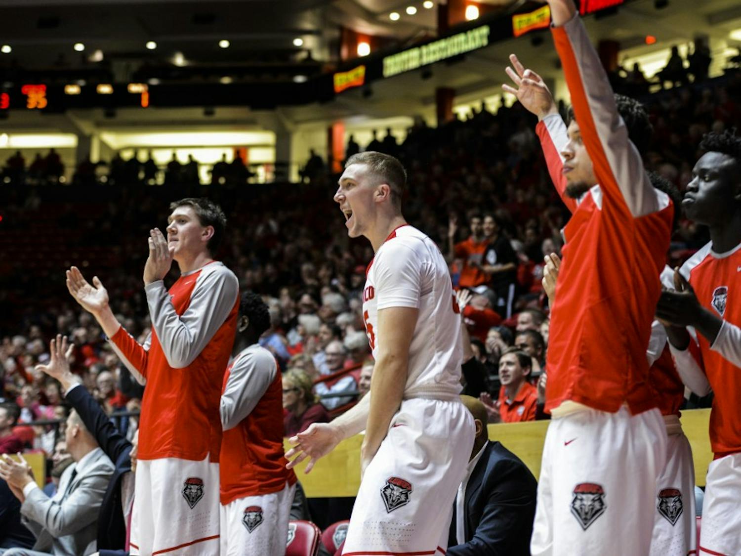 Redshirt sophomore forward Connor MacDougall, center, celebrates with his teammates Tuesday, Jan. 24, 2017 at WisePies Arena. The Lobos defeated Utah State 74-61, making their conference record 6-3.&nbsp;