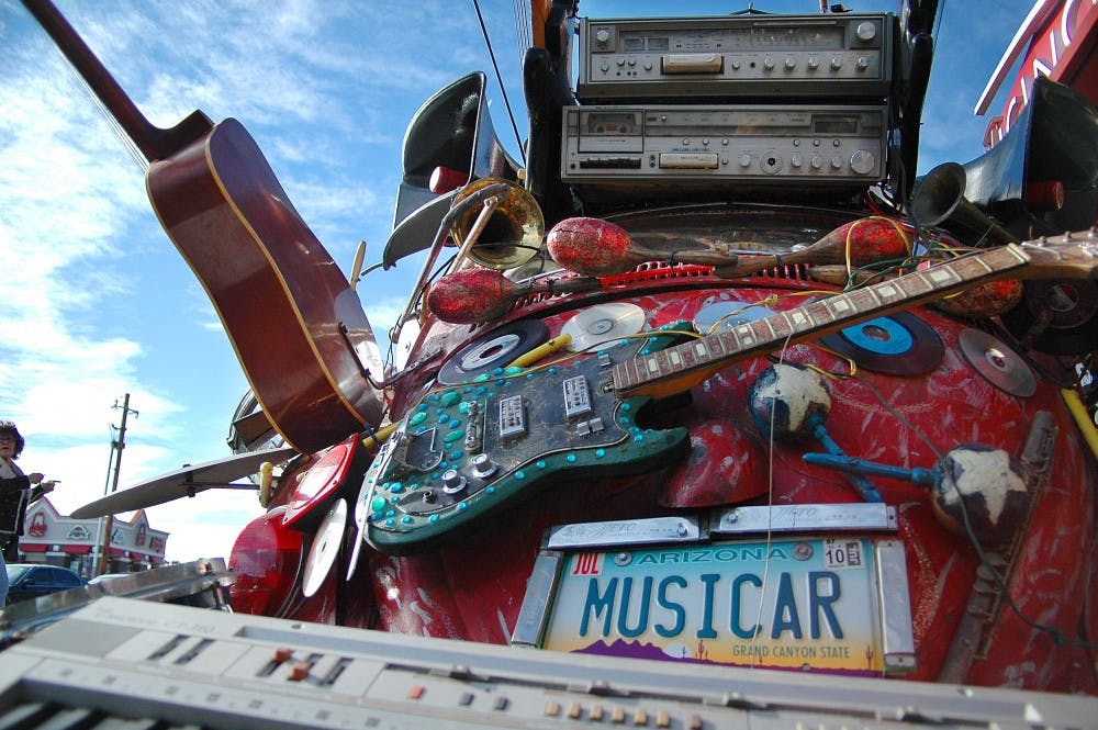 	Hunter Mann is the maker of “musicar” and displayed his car art outside The Guild on Sunday. Mann is on the Board of Directors for Art Car World Museum.