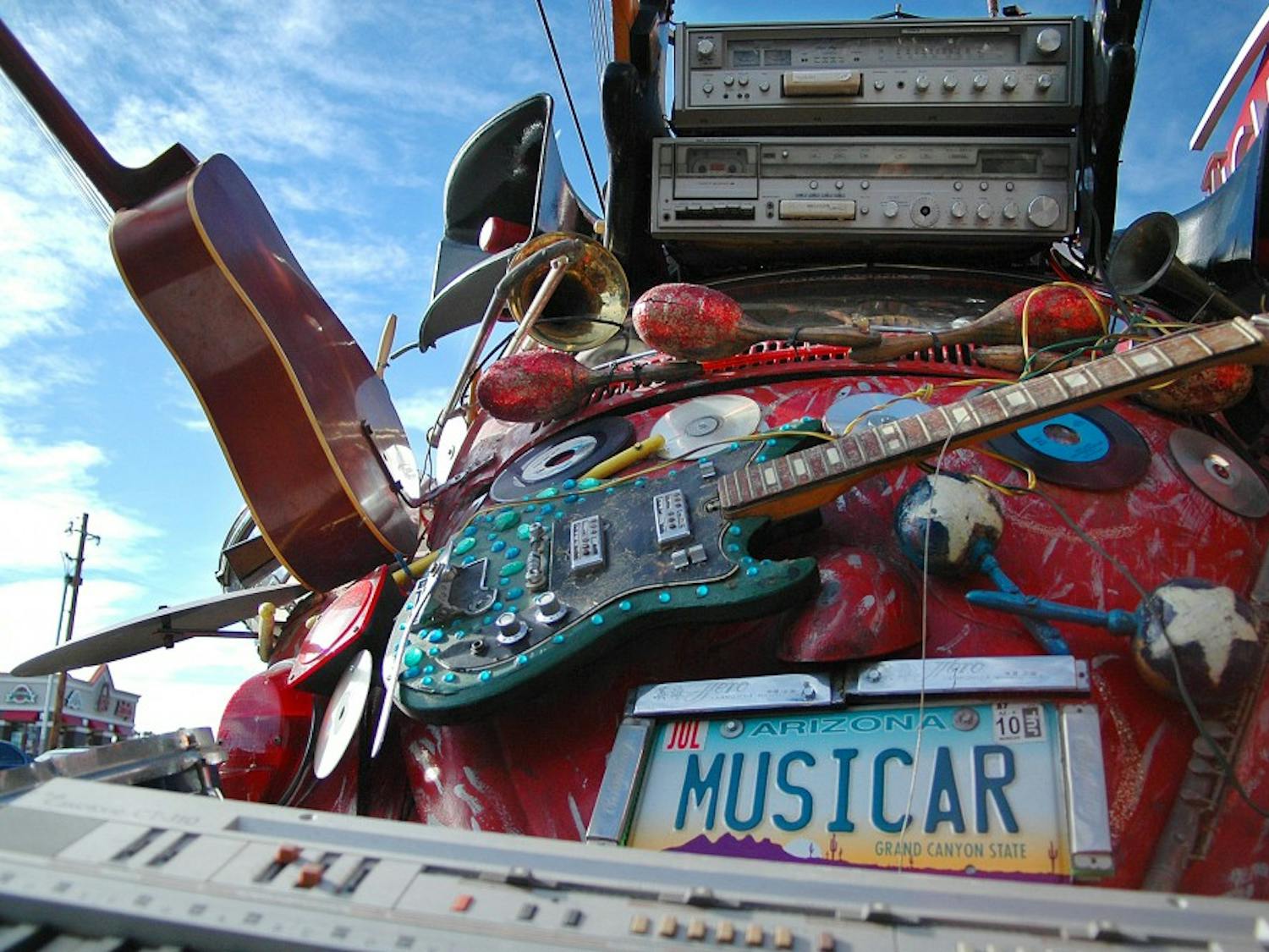 	Hunter Mann is the maker of “musicar” and displayed his car art outside The Guild on Sunday. Mann is on the Board of Directors for Art Car World Museum.