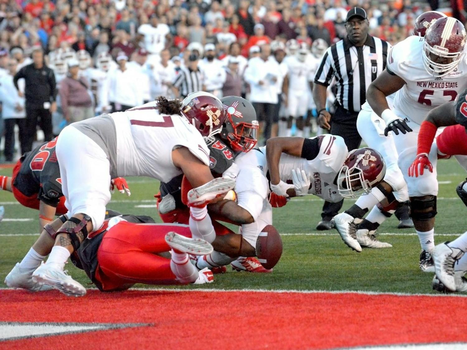 Lobo linebacker Maurice Daniels (58) brings down NMSU running back Larry Rose III, resulting in a fumble recovery and touchdown for UNM. The Lobos play Hawai’i on Saturday at University Stadium.