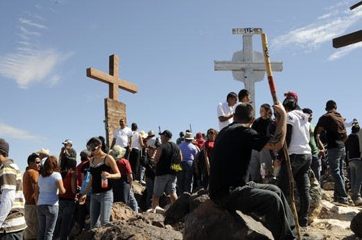 Pilgrims gather around crosses atop Tome Hill, near Belen, on Friday. Many Christians traveled to the site for Good Friday, the day remembered for Jesus Christ's crucifixion three days before Easter.