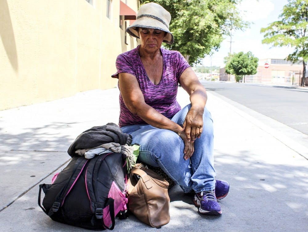 Carolyn awaits the Joy Junction bus Saturday afternoon near the Rail Yards. She has been homeless in the Albuquerque area for six months. Carolyn finds reprieve from the heat by either frequenting a convenience store or staying at Joy Junction or local churches. 