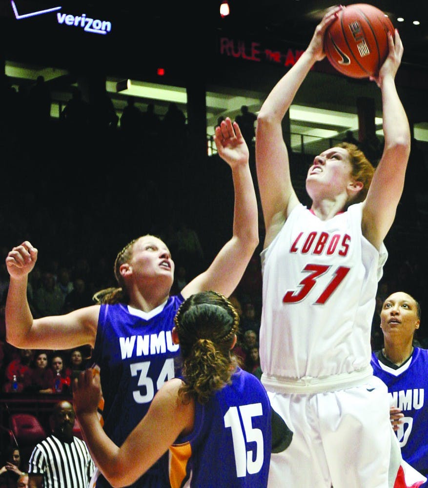 	In the paint, Erin Boettcher puts up a shot in between Western New Mexico’s Larissa Loera (15) and Kristina Barr at The Pit on Tuesday. The UNM women’s basketball team will open its regular season in The Pit on Friday against Texas Tech.