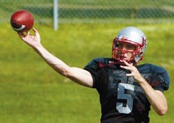Lobo backup quarterback Chris Nelson throws a pass during offensive play drills at Wednesday's practice at the Lobo football practice field.
