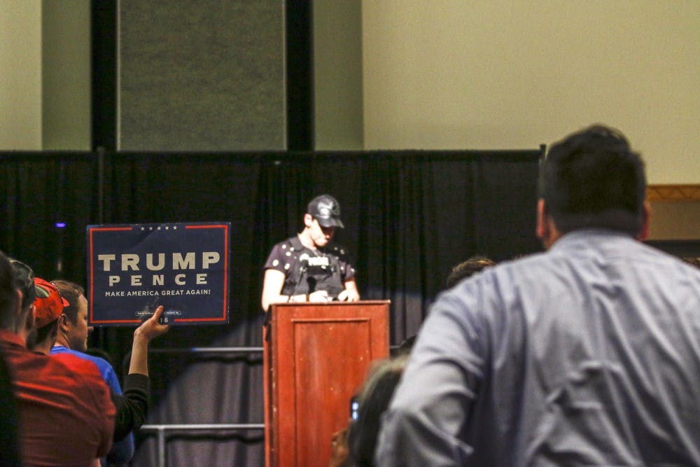 A Donald Trump supporter holds a sign as alt-right personality Milo Yiannopoulos speaks Friday, Jan. 27, 2017.