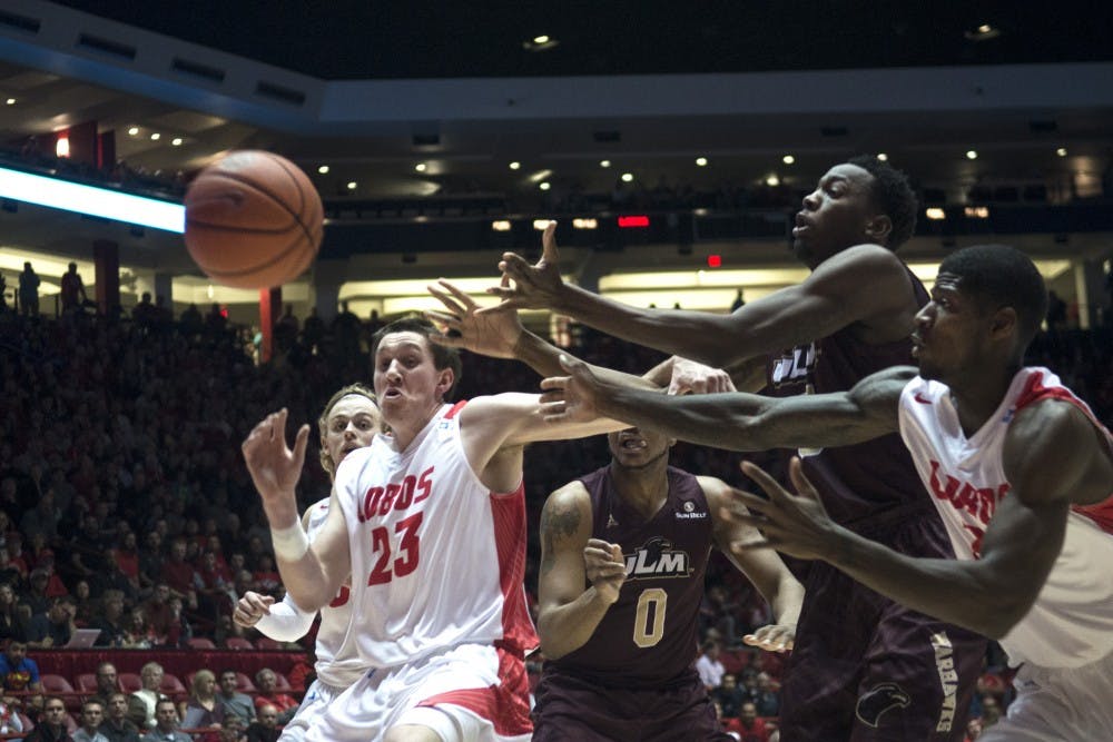 New Mexico and UL Monroe players fight for possession of a loose ball during the Dec. 13 game at WisePies Arena. The Lobos defeated the Warhawks 54-46.