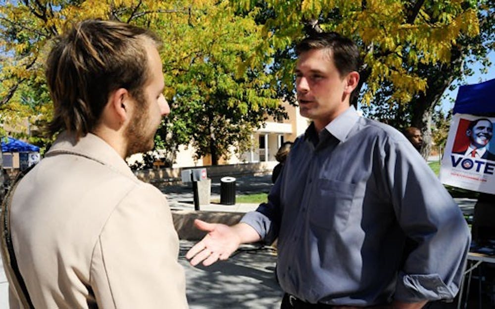 Congressional candidate Martin Heinrich, right, speaks with student John Besante near the SUB on Tuesday. 