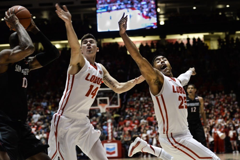 Freshman guard/forward Dane Kuiper (14) and senior guard Tim Jacobs (25) try to defend a San Diego State player Tuesday night at WisePies Arena. The Lobos will play Nevada this Saturday in Reno at 8 p.m.