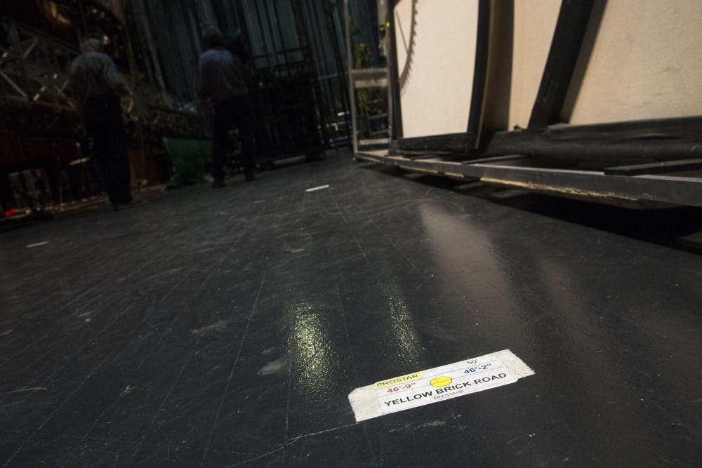 A spike, or marker, to indicate the correct placement for the Yellow Brick Road that will be featured in “Wicked”.