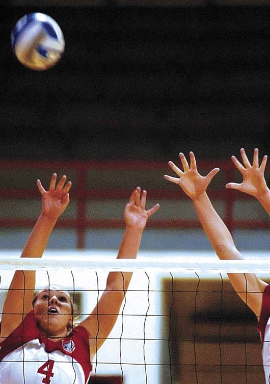 Lobo setter Sarah Kwasigroch tries to hit a ball sent over by San Diego during the Lobos' 3-0 shutout Friday at Johnson Center. Kwasigroch had a double-double with 47 assists and 14 digs.