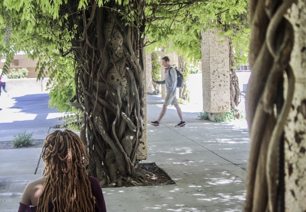 Goldie Okoye, a nursing major, studies on April 18, 2018 underneath the wisteria arbor, the 10th stop in the Arbouretum tour on UNM campus.