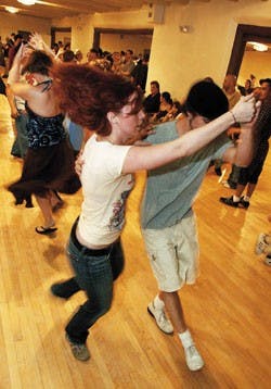 UNM student Kevin Clark, right, dances the Lindy Hop with Grace Lerner on July 25 at the Heights Community Center's Swing Night.