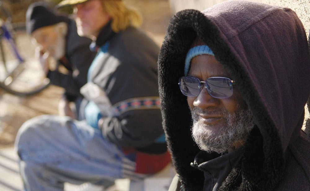 Bobby Shelton sells newspapers outside the Bookstore on Monday. Shelton moved here from Roswell, N.M., in 1977.