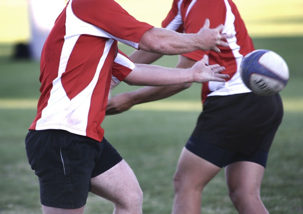	Drew Riordan tosses the rugby ball at a UNM rugby team’s practice at Johnson Field. The team has been ranked as high as No. 11 in the country.