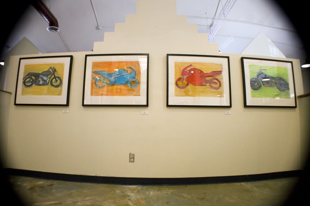 	A series of images called “Keeping It Shiny Side Up” by Jacqui Lewnes hangs at the Chroma Studios on Wednesday. The show is open through Saturday. 