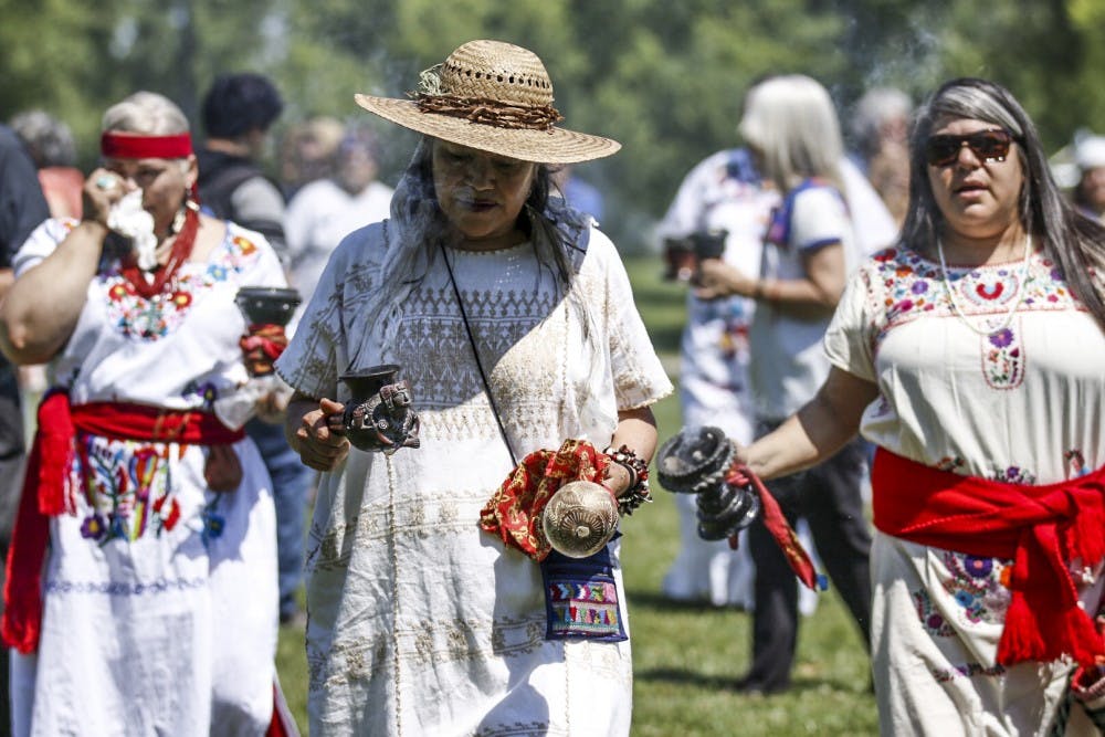 After the group formed two circles, leader Rita Navarrete, center, leads the way to gather members to do an activity where incense was burned. This group plans to meet every week as a way to reach out to the community.