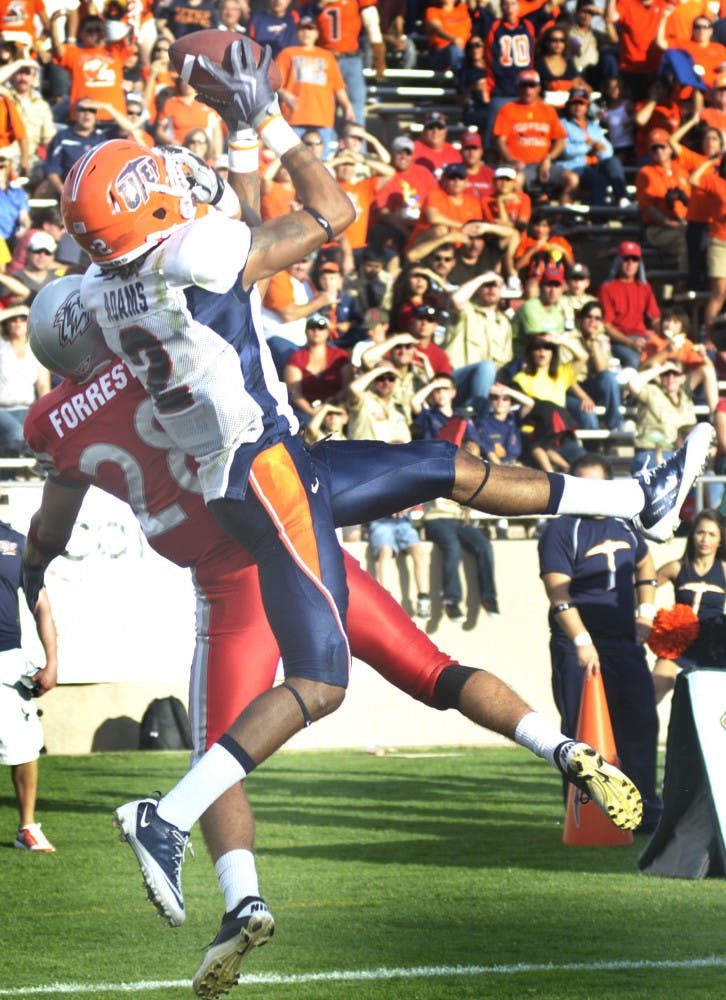 	UNM defensive back Bubba Forrest attempts to defend UTEP wide receiver Kris Adams during Saturday’s game at University Stadium. The Miners defeated the Lobos 38-20 to drop UNM to 0-5.
