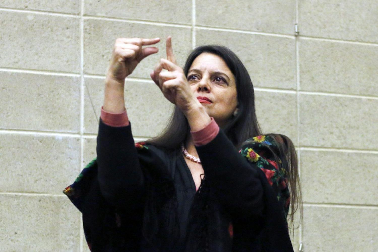 Teresa Blankmyer Burker teacher of philosophy in ASL at the institution of Gallaudet University   recites one of her poems in American Sign Language during the Woman Empowerment poetry on March 8, 2016 at the Hispanic Cultural Center. the female poets consisted from a variety of ages. 