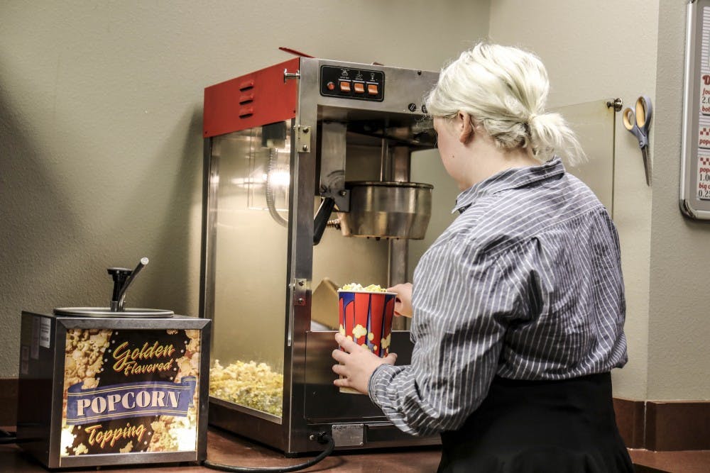 Anneliese Ward, scoops popcorn for theatre patrons at the Southwest Film Center at the SUB on Sept. 09, 2017. Part of Wards duties include working the projection room and concessions. The SWFC offers a $15 semester pass for UNM students to watch all movies screening throughout the semester. 