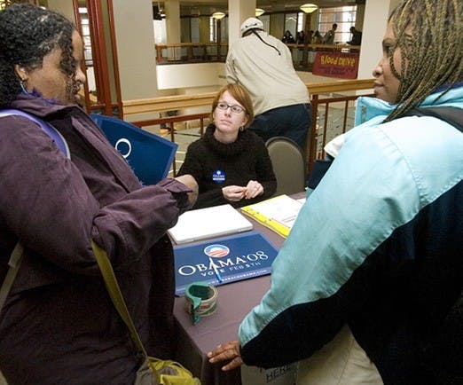 Students KJ Always, left, and Nancy Henderson talk to Gillian Joyce, a volunteer with Sen. Barack Obama's campaign, in the SUB on Monday. 