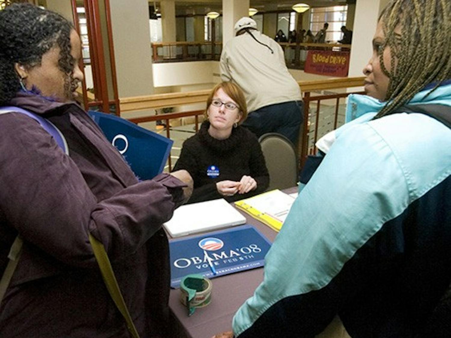 Students KJ Always, left, and Nancy Henderson talk to Gillian Joyce, a volunteer with Sen. Barack Obama's campaign, in the SUB on Monday.
