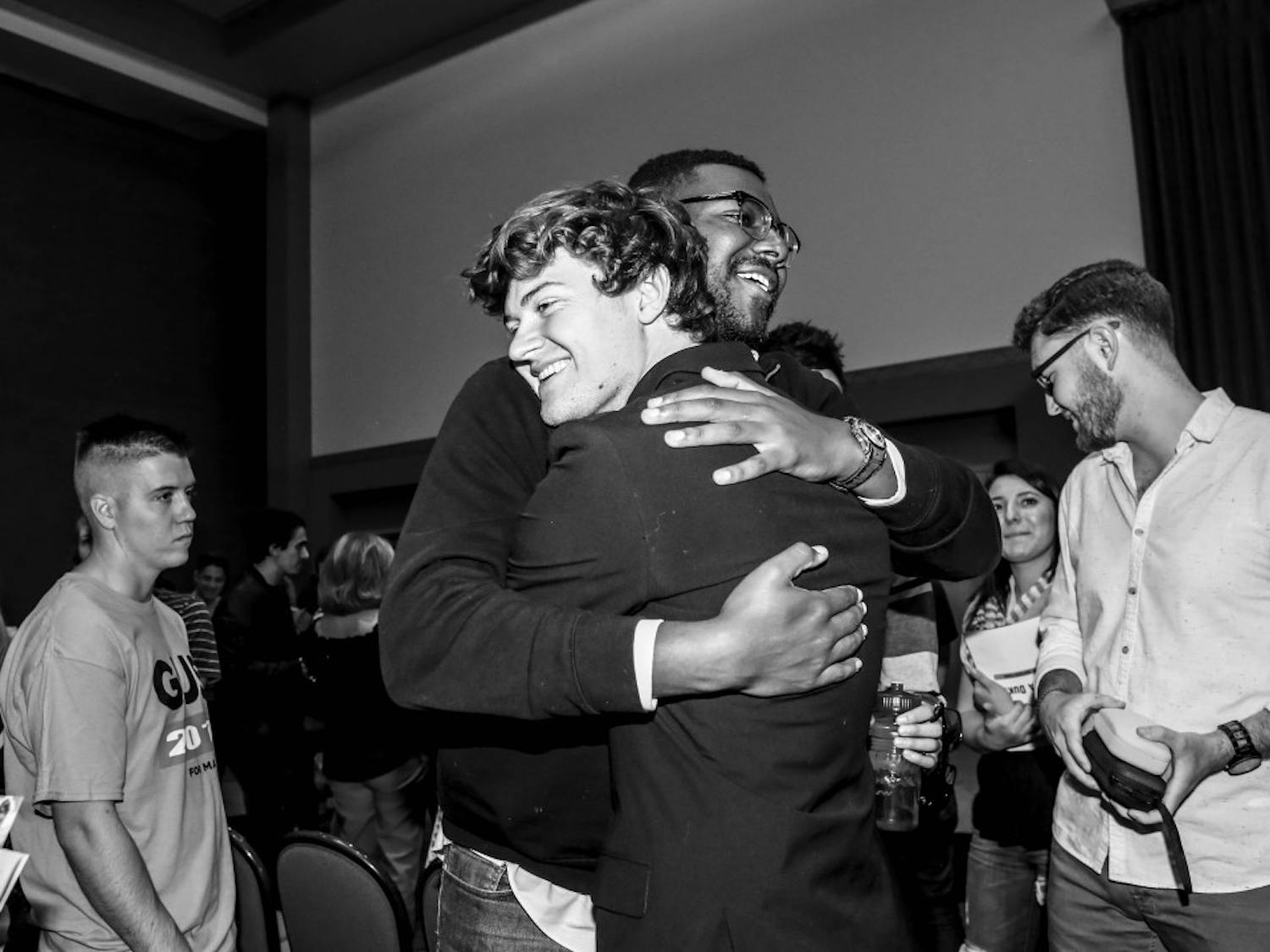 Joshua Reeves, left, embraces mayoral candidate Augustus ?Gus? Pedrotty on Saturday, Sept. 28, 2017 after the mayoral debate forum at the SUB ballroom. 