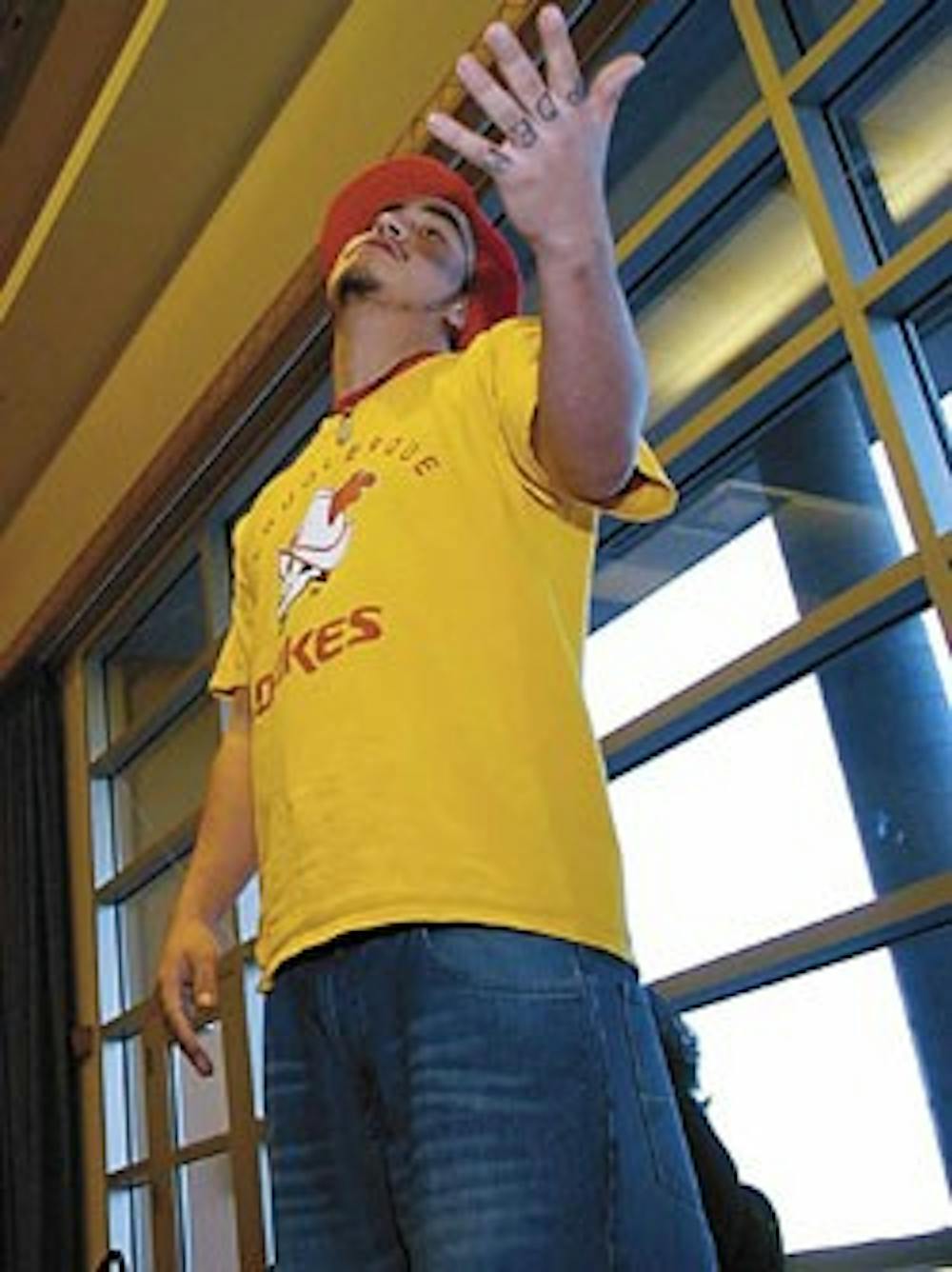 Student Carlos Contreras recites a bilingual poem during "The Politics of Language" symposium Thursday in the SUB.    