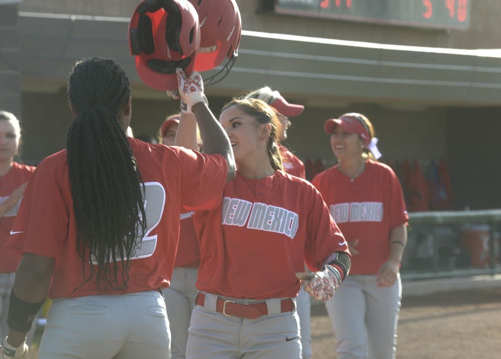 Sophomore infield player Jasmine Casados high-fives a teammate after her home run on Friday afternoon. The Lobos play against Colorado tonight at 5 p.m. at Lobo Field. 