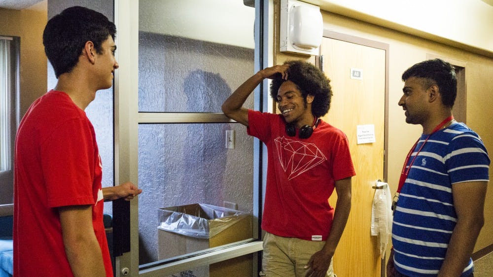 Anmol Baniya, right, a freshman international studies major, speaks with his friends at Hokona Hall on Wednesday. At their next full meeting, the Board of Regents will vote on whether or not to require incoming freshman to live on campus. 