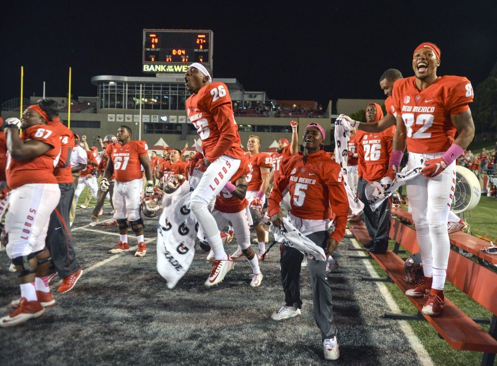 The Lobos stand up from the bench and root as their defense holds down the University of Hawaii while the clock runs out at University Stadium Oct. 17, 2015. UNM turned the game around with a couple of minutes to spare and beat out Hawaii 28-27. 