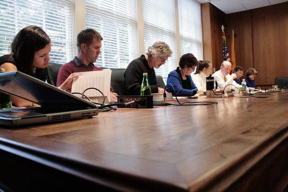 	Members of the Board of Regents look through the agenda during the Student Affairs
Committee meeting held in Scholes Hall Wednesday. One of the main topics on the agenda
was student advisement.