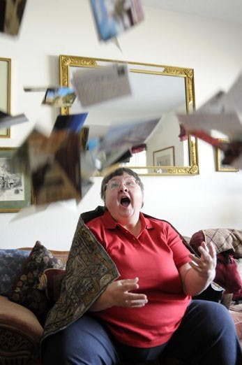 NM Postcard Club head Nancy Tucker in her home on Tuesday. 